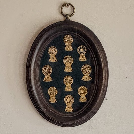 A Framed Collection of Antique Verge Watch Cocks